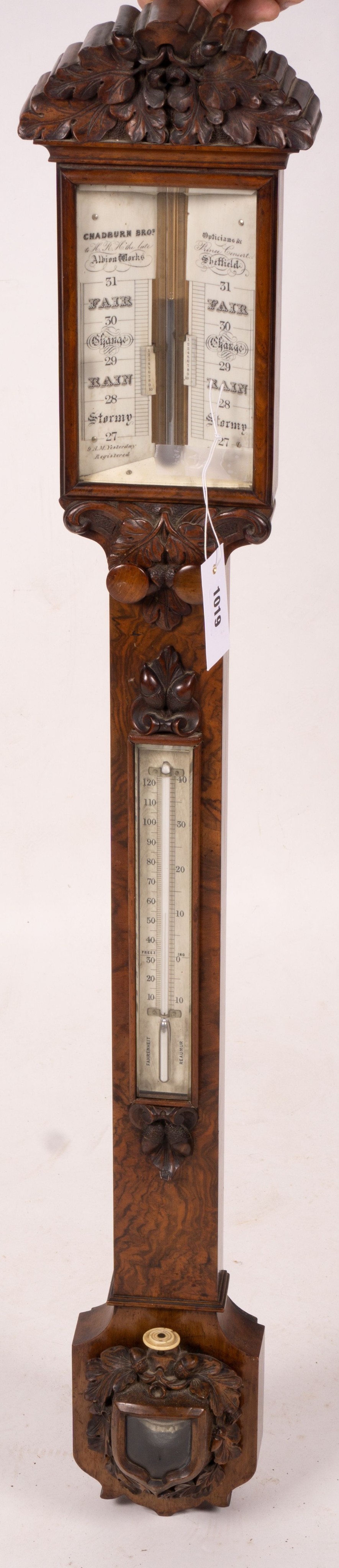 A Victorian carved walnut stick barometer by Chadburn Bros., Sheffield, height 104cm